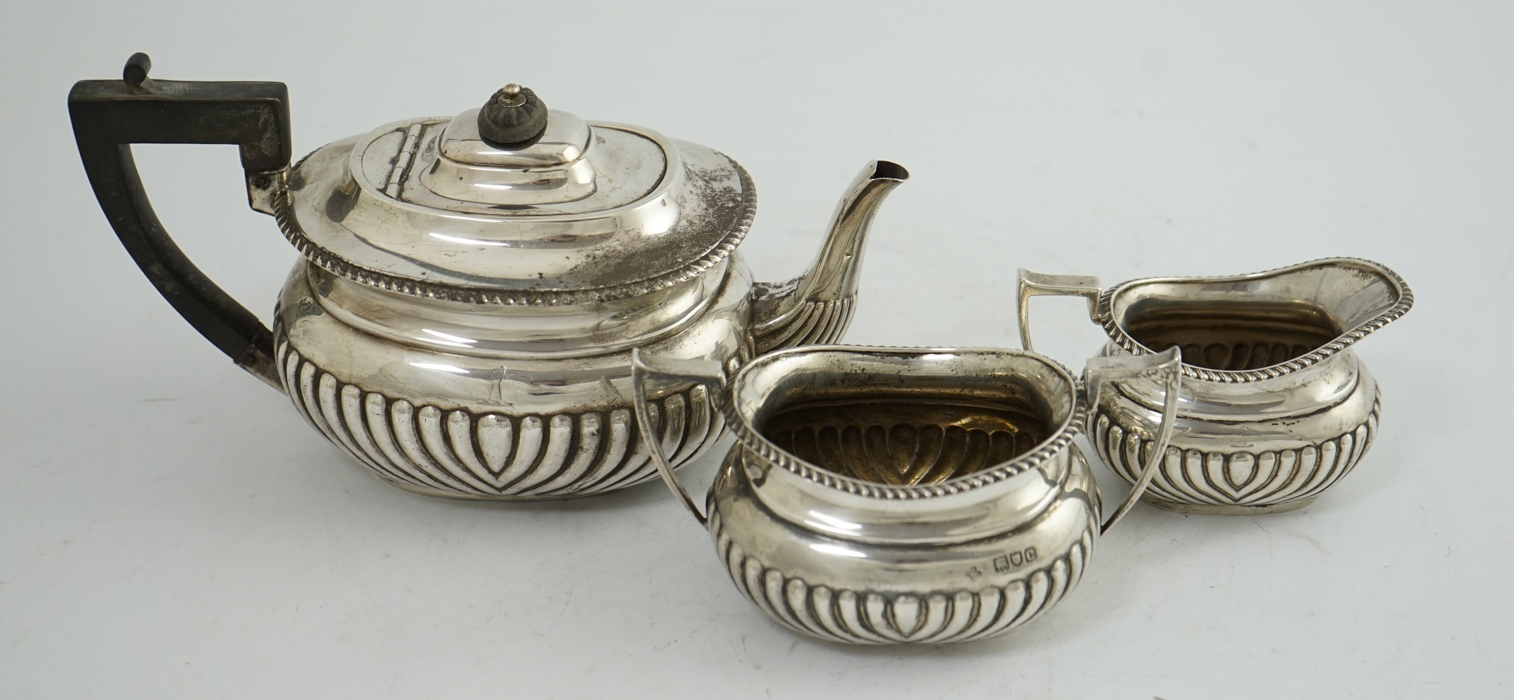 A late Victorian demi-fluted silver three piece tea set, by Horace Woodward & Co Ltd